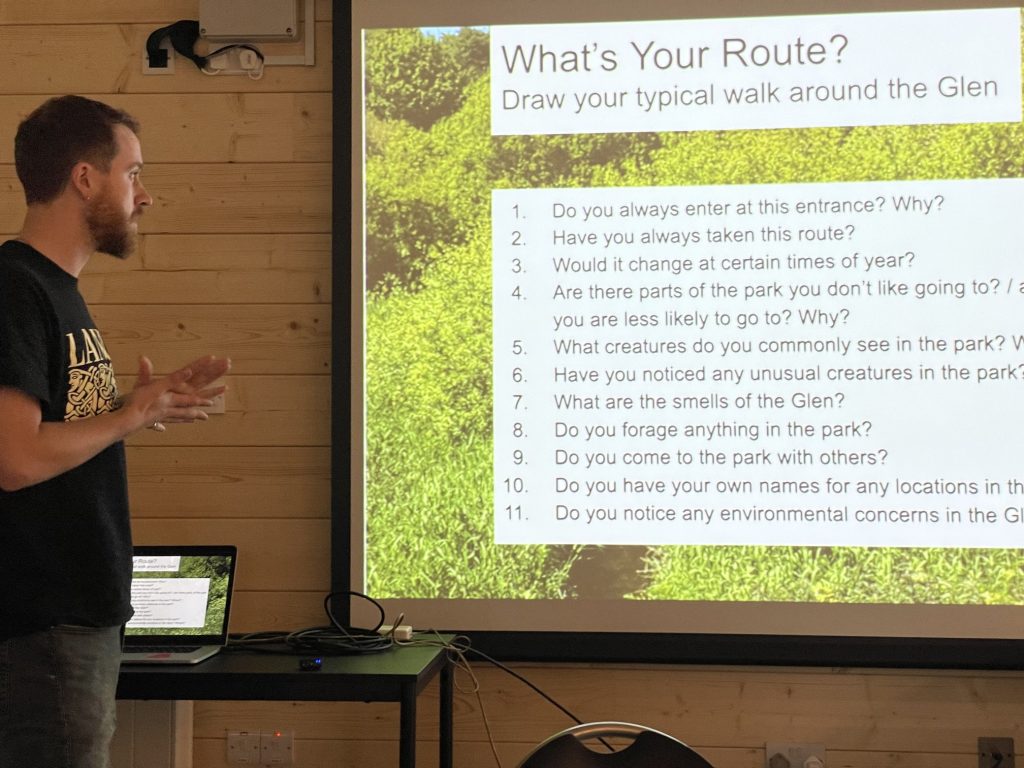 An image of a man in front of a slide presentation asking questions about the park.