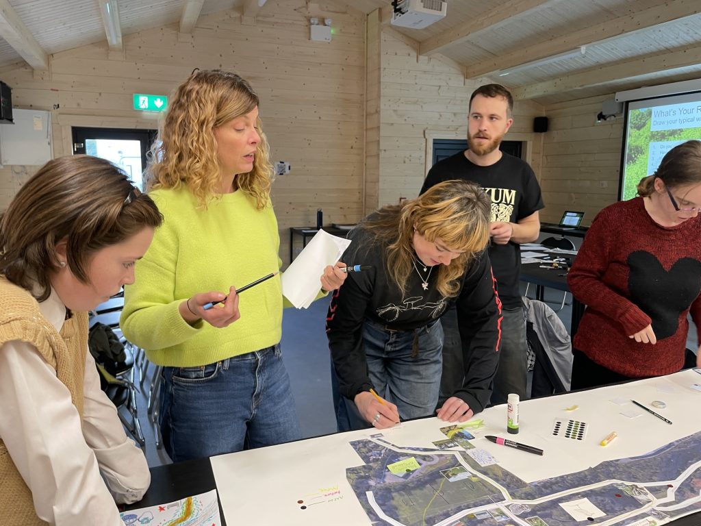 a group of people are gathered around a map