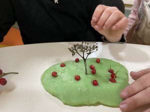 A child's hand and a model of a tree