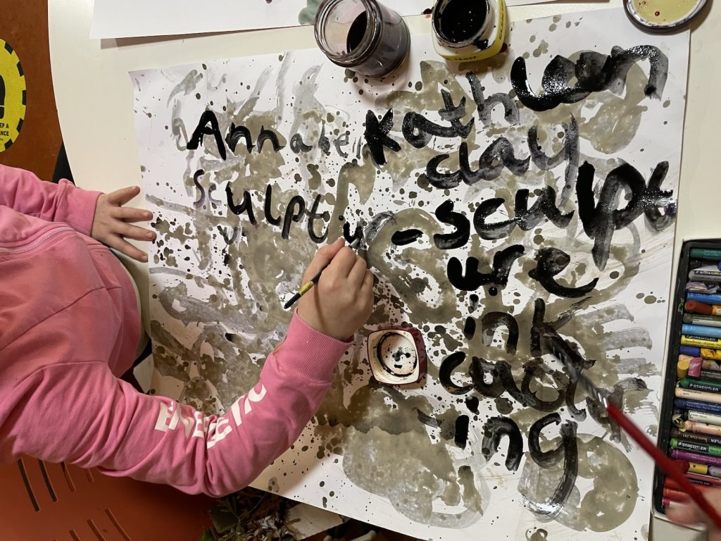 A child painting with ink