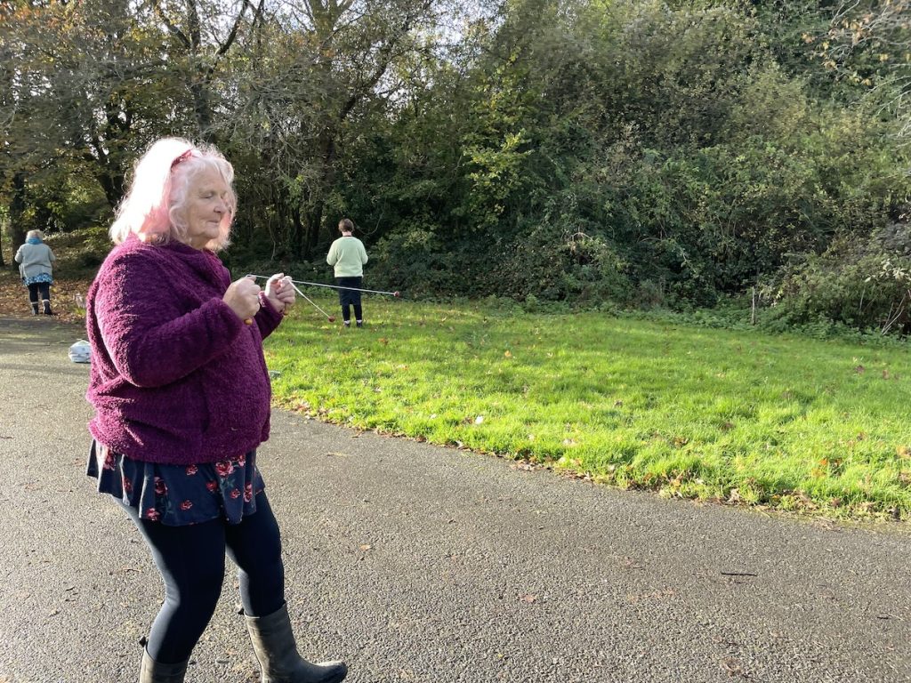 a woman walking with divining rods in her hands