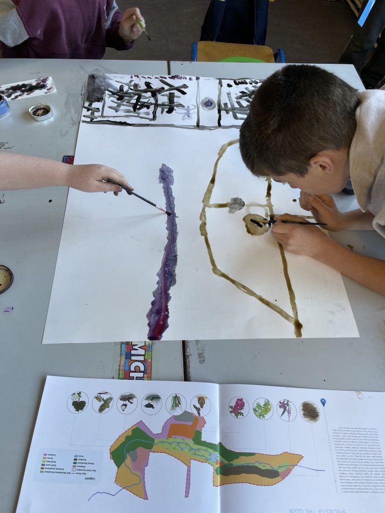 A photograph of boys creating a map 