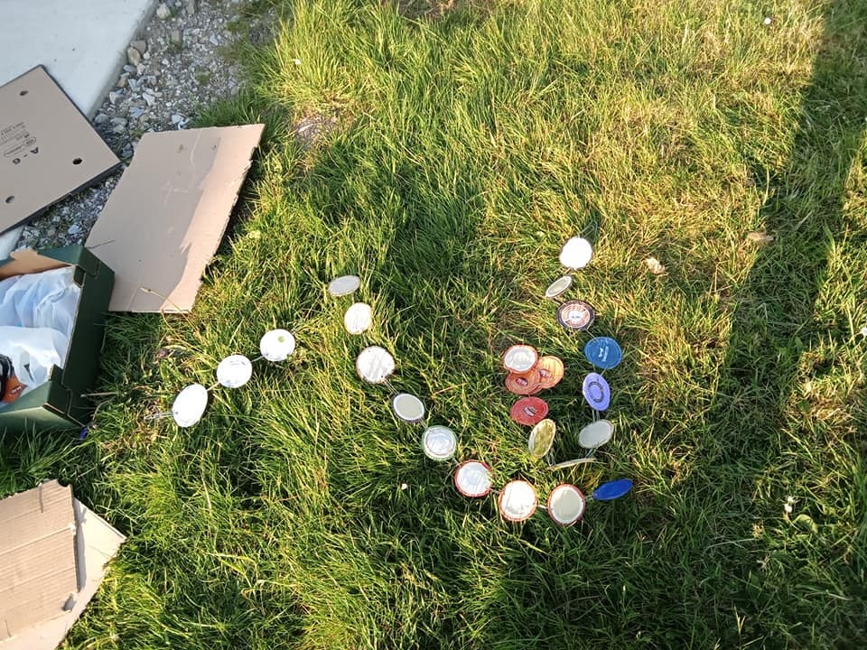 a photo of hammered lids on the grass