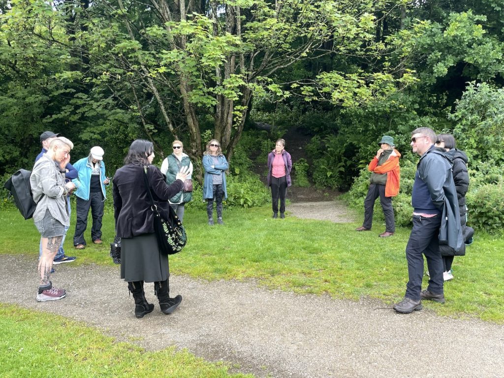 A photo of a circle of people outdoors