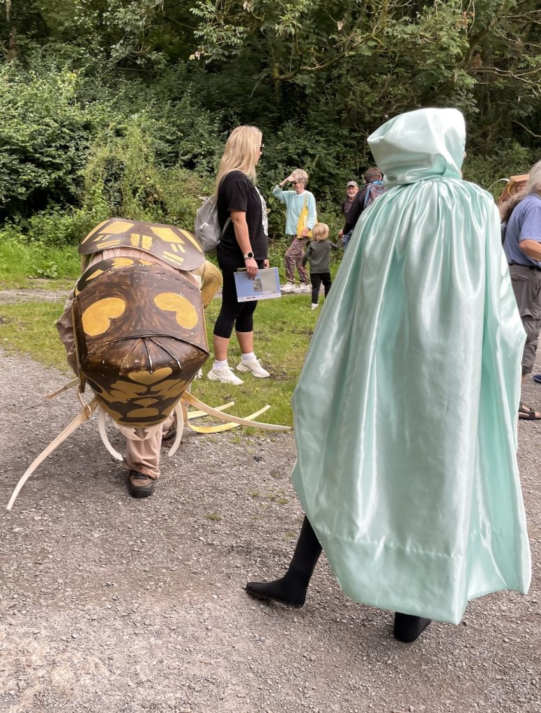 a photo of a woman dressed up as the river guardian greets a man dressed up as a stonelly