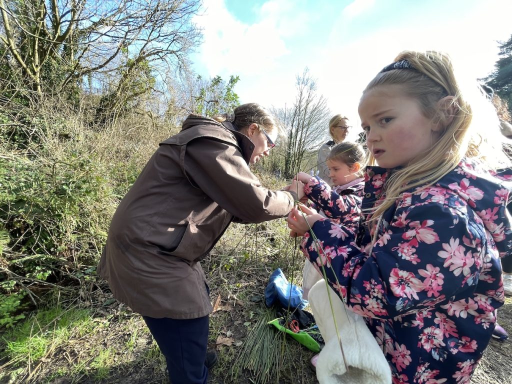 A photo of children making Brigid's crosses