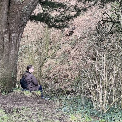 a photo of a woman under a tree by the river