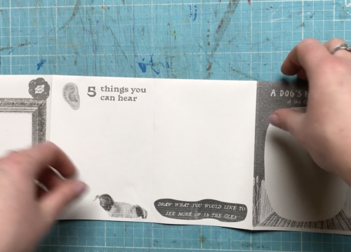 A still from the video showing how to fold a zine