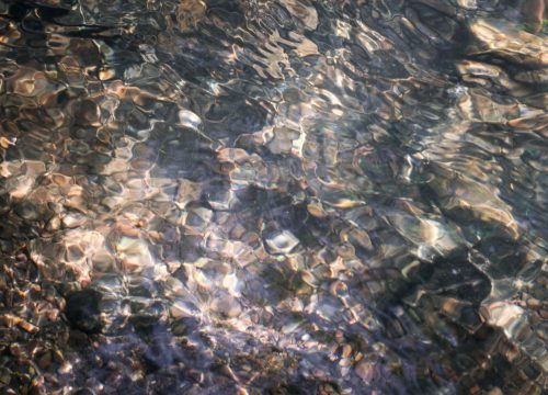 film still close up of water and river bed by Dervla Baker