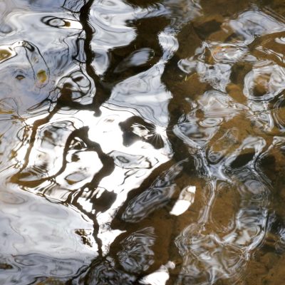 a photo clos-up of river water showing reflected patterns